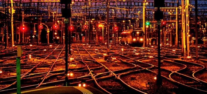 railway tracks and signals at an empty train station at sunset