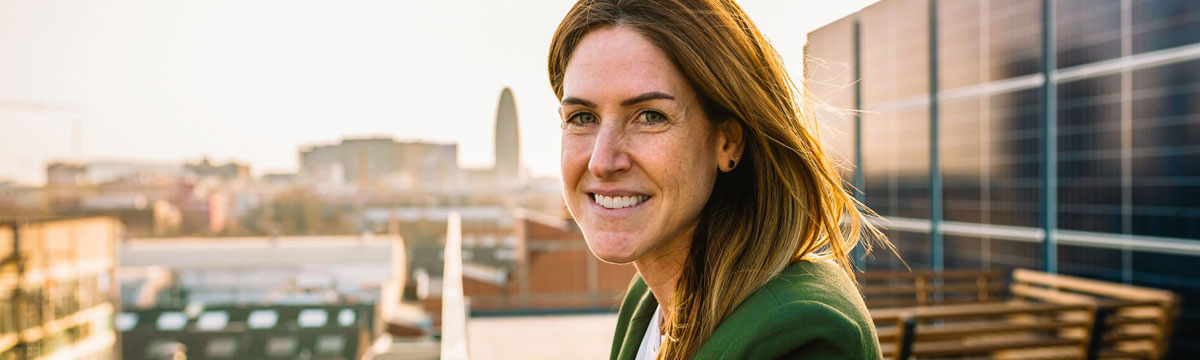 Woman looking into the camera on top of an office building