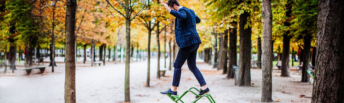 a man standing on top of a chair trying to stay in a balance